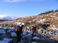 Not an easy stream crossing - the rocks were glazed with ice. John (standing on ice) wondering why he hadn't thought up a better excuse that morning